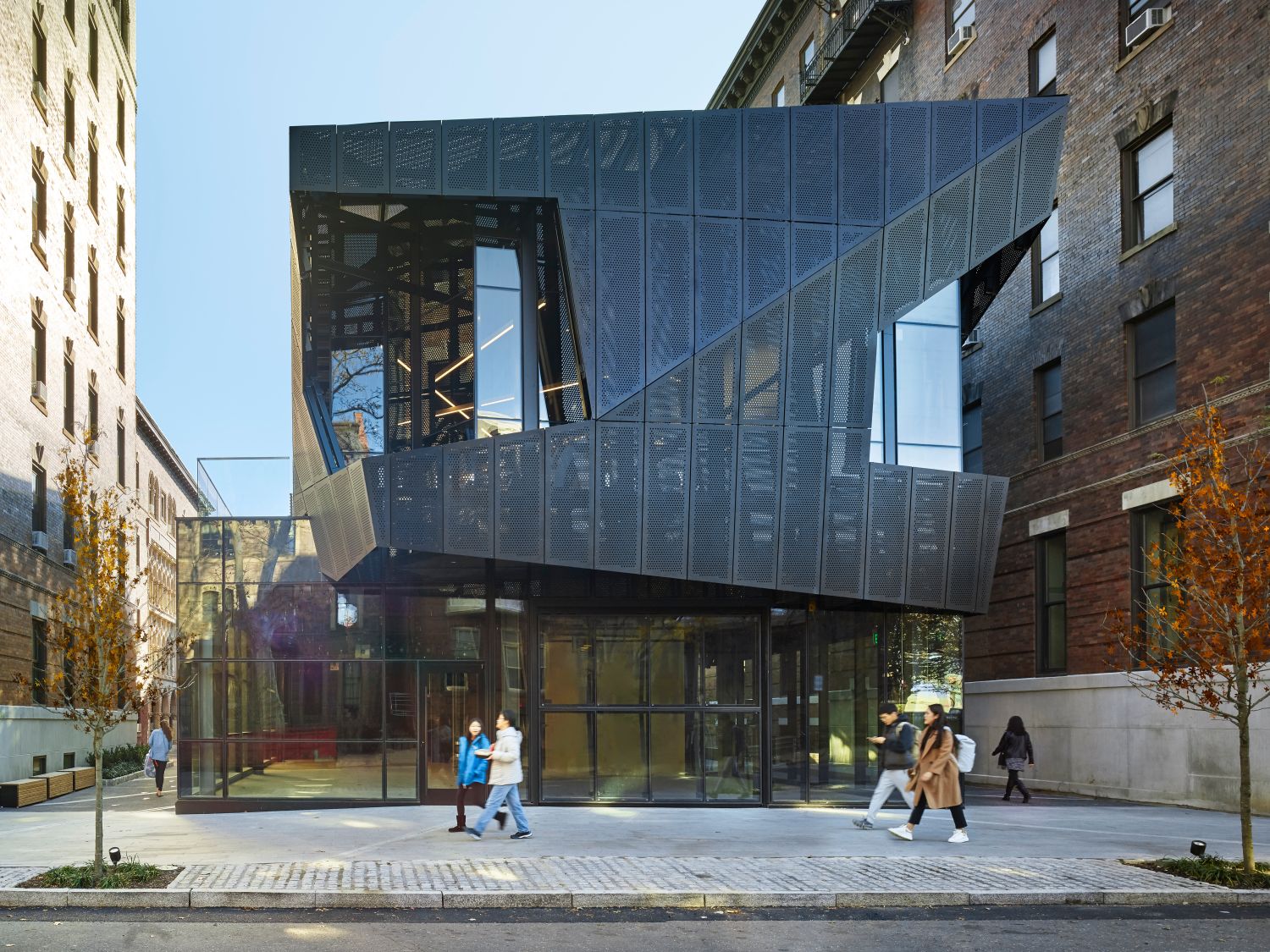 An exterior front view of Hamilton Court with people passing by