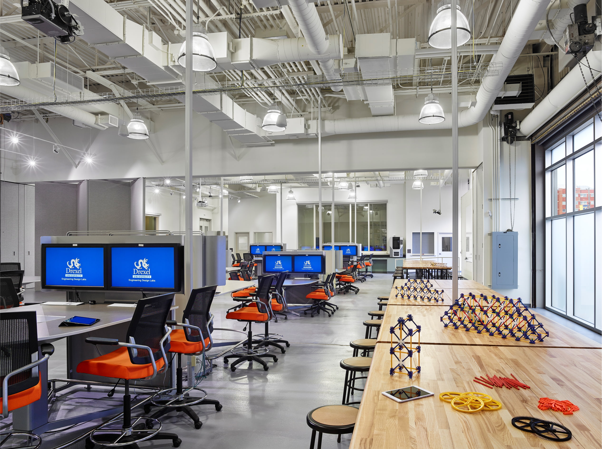 Broad office space with a lot of desks/chairs/and monitors
