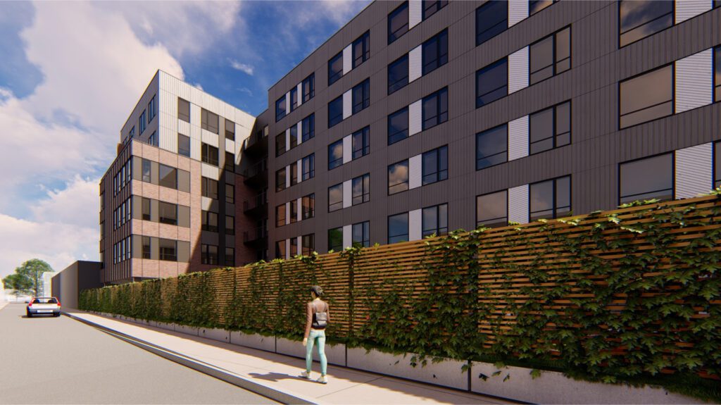 1700 N Howard Street exterior - fence view with a woman walking by