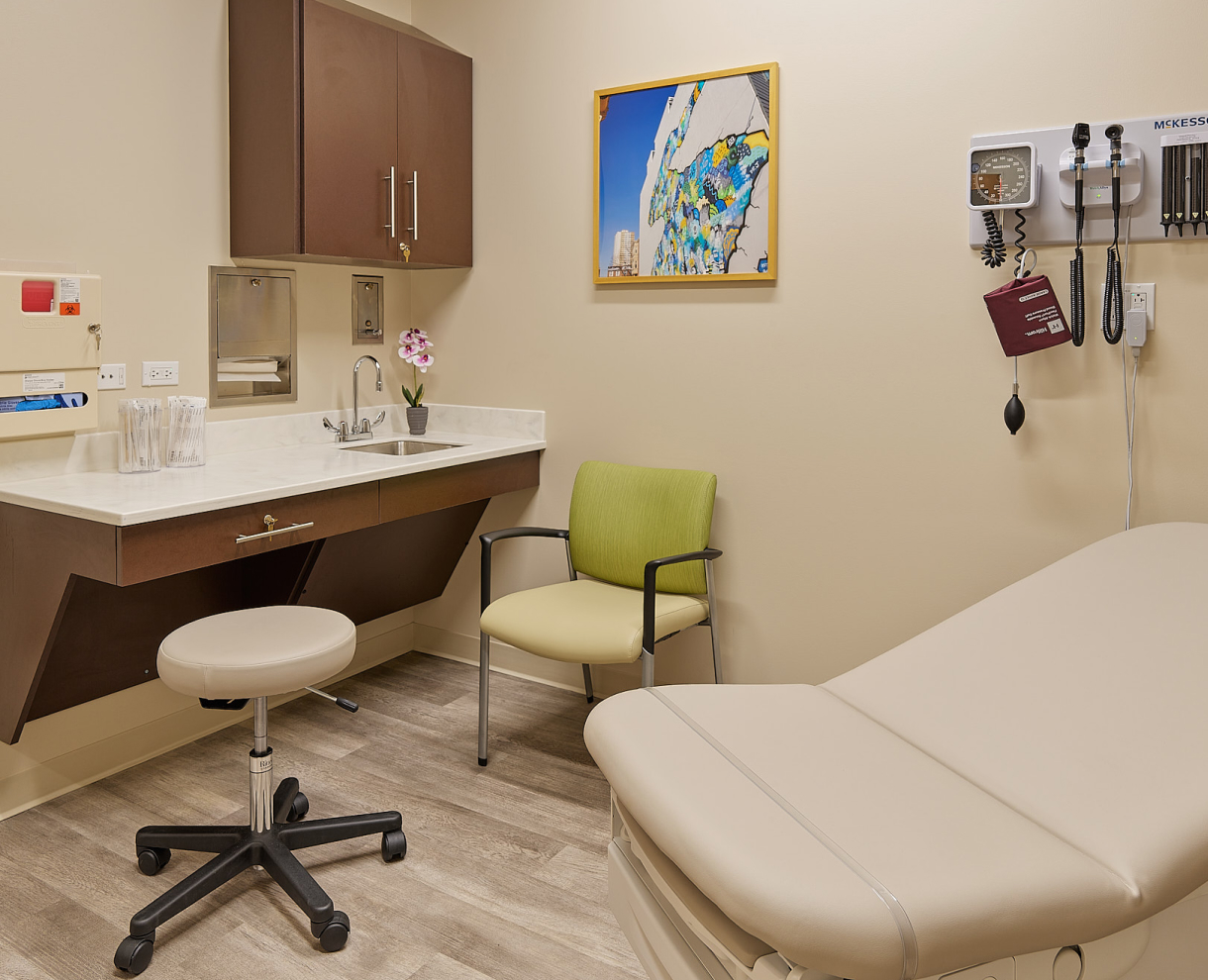 OSH examination room with a bed, chair, and medical equipment